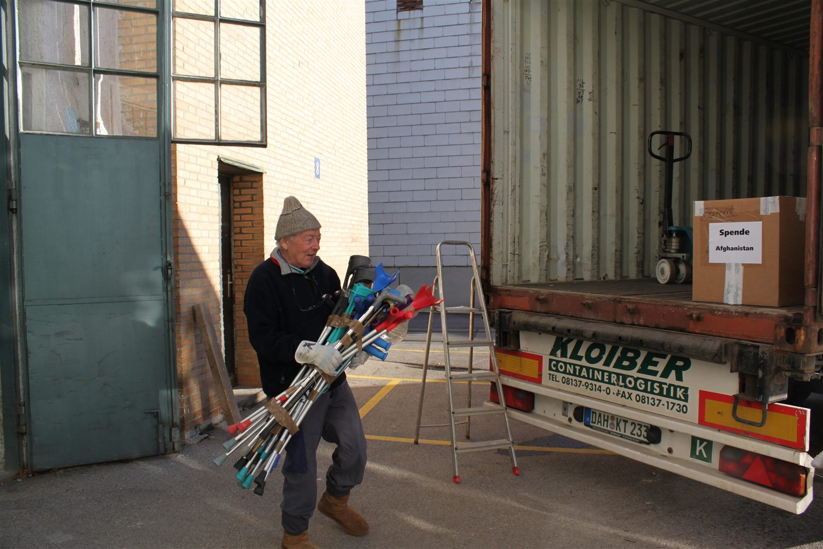 Rudolf, carrying crutches to the container